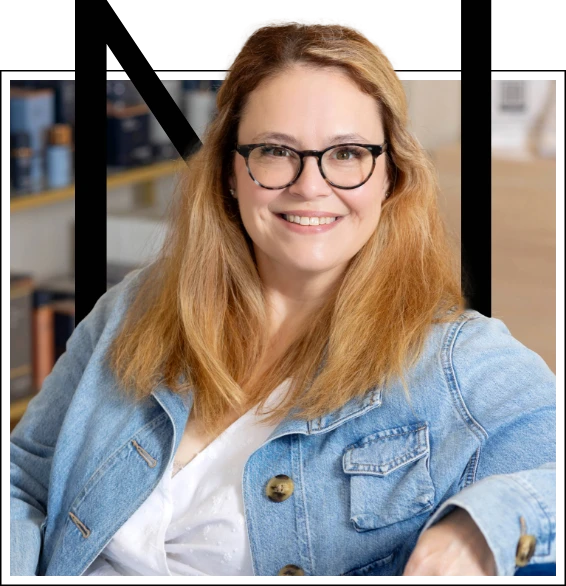 a woman wearing glasses and a denim jacket